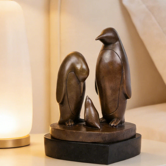 This penguin family brass sculpture captures a tender moment between three penguins, rendered in clean, minimalist lines that emphasize form, balance, and emotional connection. Expertly crafted from solid brass, the sculpture features a warm, natural finish that enhances its timeless character and tactile appeal.