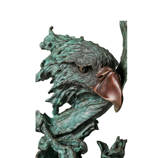 abstract bronze eagle head sculpture with striking verdigris patina and marble base. A bold wildlife statue symbolizing freedom, strength, and vision.
