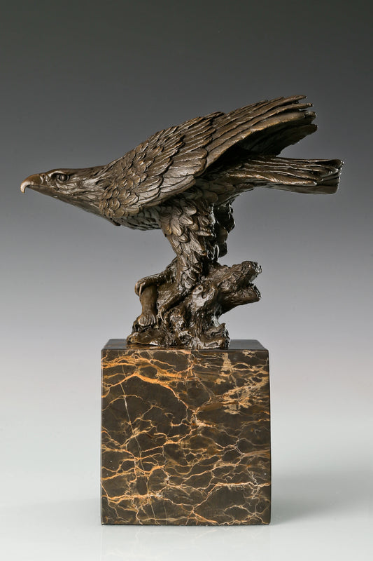 Bronze eagle sculpture ready to fly with wings partially spread and marble base. A powerful symbol of strength, freedom, and ambition.