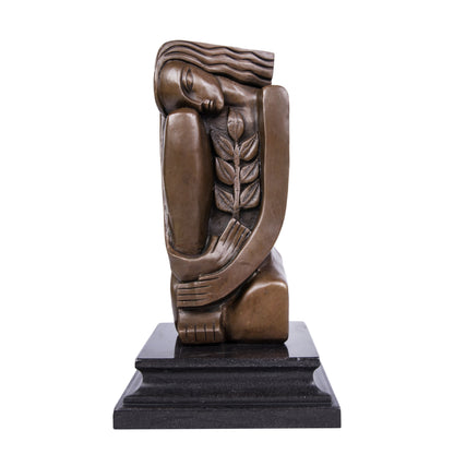This is a modern abstract-style sculpture made of bronze:It depicts a female figure in a curled posture: her eyes are gently closed, her long hair falls naturally, her arms wrap around herself to form a soft wrapping sense, and an olive branch (a classic symbol of peace) is embedded on one side of her body. The overall lines are clean and concise, the bronze texture is deep and gentle, and it is matched with a black stone base. 