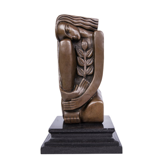 This is a modern abstract-style sculpture made of bronze:It depicts a female figure in a curled posture: her eyes are gently closed, her long hair falls naturally, her arms wrap around herself to form a soft wrapping sense, and an olive branch (a classic symbol of peace) is embedded on one side of her body. The overall lines are clean and concise, the bronze texture is deep and gentle, and it is matched with a black stone base. 