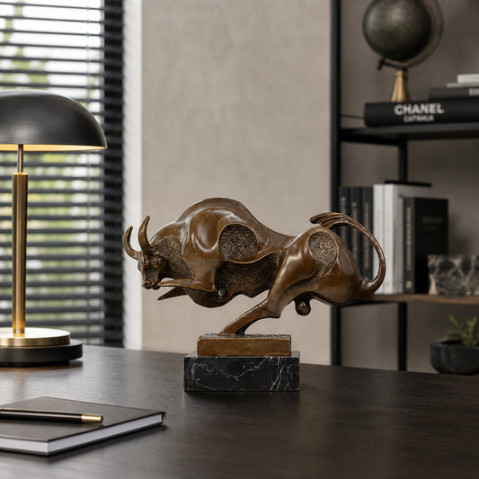 Contemporary abstract bronze charging bull sculpture with polished curves and textured voids, modern geometric animal statue on black marble base, loss wax casting fine art.