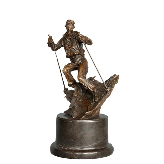 This is a dynamic bronze sculpture of a skier, crafted using the lost-wax casting method. The piece captures the athlete mid-action, navigating a rugged, snow-like terrain with ski poles firmly in hand and legs bent in a powerful stance. The rich, warm bronze patina accentuates the fluid folds of the skier’s jacket and pants, as well as the textured, naturalistic base that simulates a snow-covered slope.