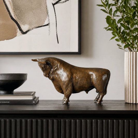 Lifelike standing bronze bull sculpture with muscular anatomy, realistic animal statue with warm brown patina, loss wax casting fine art for office decor.
