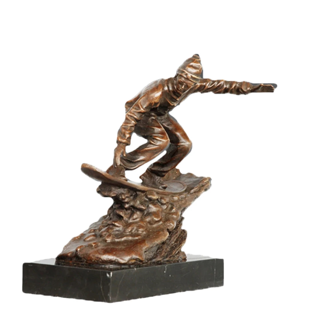 This is a dynamic bronze sculpture of a snowboarder, crafted using the lost-wax casting method. The piece captures the athlete mid-action, crouched low on their board while navigating a rugged, snow-like terrain, with one arm extended for balance. The rich, warm bronze patina accentuates the fluid folds of the snowboarder’s jacket and pants, as well as the textured, naturalistic base that simulates snowdrifts.