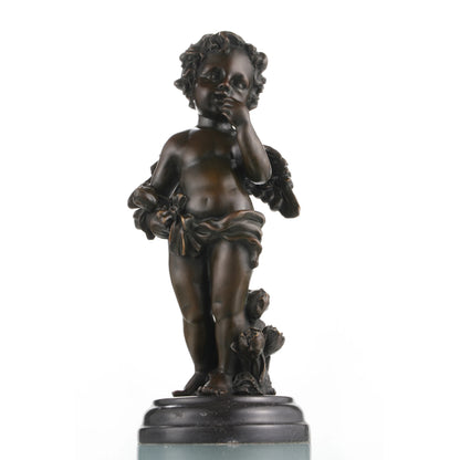 Classical bronze cherub statue standing on roses with finger to lips, winged cupid angel sculpture on circular black marble base, loss wax casting romantic art.