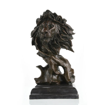 This is a striking bronze bust of a lion, crafted using the lost-wax casting method. The sculpture focuses on the lion’s head and upper neck, capturing the animal in a moment of quiet intensity, with its mane rendered in dynamic, flowing forms that suggest movement and raw power. The deep, rich bronze patina accentuates the intricate details of the lion’s facial features—from the intense gaze of its eyes to the texture of its whiskers—and the dramatic, almost wind-swept folds of its mane.