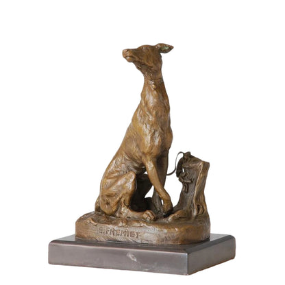 This refined bronze sculpture of a seated greyhound is crafted using the traditional lost-wax casting method and bears the signature of Emmanuel Frémiet. The dog is depicted in an alert seated pose, its head slightly raised, conveying elegance and keen attention. The warm bronze patina highlights its lean musculature and smooth coat, while the naturalistic base—featuring a stylized tree stump and small rabbit—adds narrative depth. 