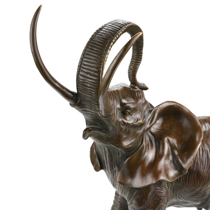 a majestic bronze elephant sculpture featuring realistic textures and raised trunk symbolism. A powerful wildlife statue symbolizing strength, wisdom, and prosperity.