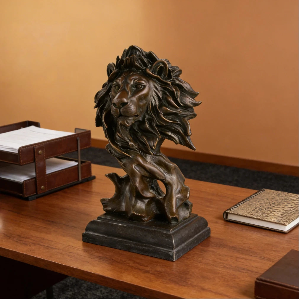This striking bronze lion bust, crafted using the lost-wax casting method, captures the head and upper neck in a moment of quiet intensity. The flowing mane, detailed facial features, and deep bronze patina convey raw power, strength, and nobility. Mounted on a stepped dark marble plinth, the sculpture offers stability and presence, making it a distinguished accent for refined interiors or art collections.