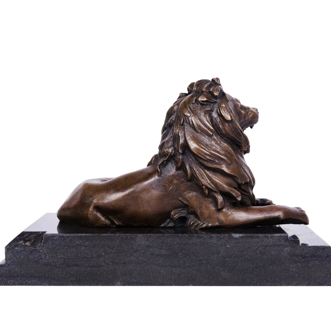 This powerful bronze lion sculpture, crafted using the lost-wax casting method, depicts the animal in a reclining pose with its mouth open in a fierce roar. The rich, aged bronze patina highlights the lion’s taut musculature and detailed mane, conveying raw strength and authority. Its raised head and alert posture suggest dominance and vigilance. 