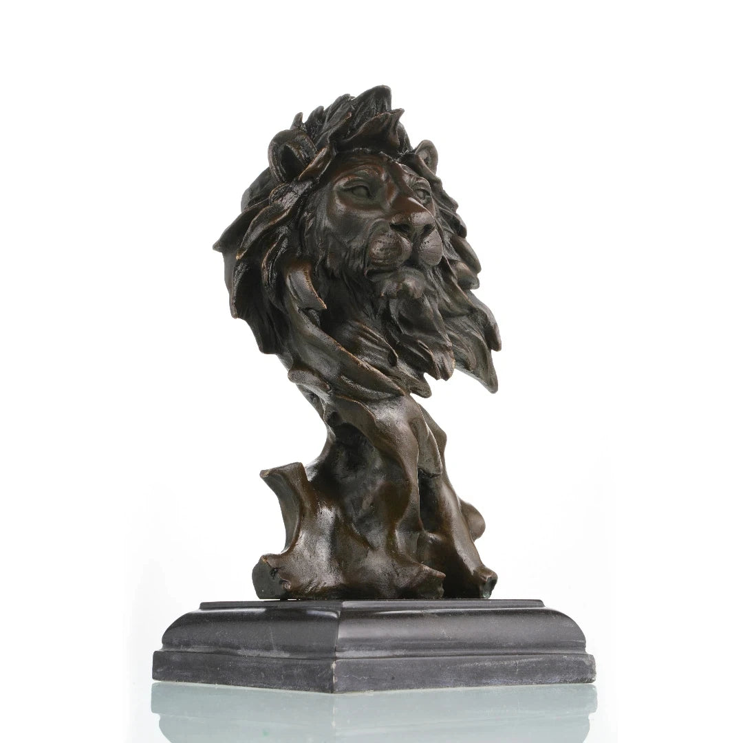 This striking bronze lion bust, crafted using the lost-wax casting method, captures the head and upper neck in a moment of quiet intensity. The flowing mane, detailed facial features, and deep bronze patina convey raw power, strength, and nobility. Mounted on a stepped dark marble plinth, the sculpture offers stability and presence, making it a distinguished accent for refined interiors or art collections.
