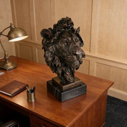 This powerful bronze lion bust is crafted using the traditional lost-wax casting method, capturing the animal’s head and upper neck with remarkable realism. The rich bronze patina highlights the lion’s piercing gaze, detailed whiskers, and dynamic, wind-swept mane, conveying strength and regal authority. The sculpture is mounted on a solid bronze block and dark marble plinth, enhancing its stability and grand presence.