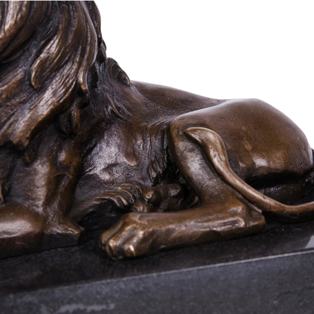 This is a powerful bronze lion sculpture, cast using the lost-wax method, depicting the animal in a reclining pose with its mouth open in a fierce roar. The sculpture features a rich, aged bronze patina that highlights the intricate, flowing details of its mane and the taut musculature of its body, conveying a sense of primal strength and authority. The lion’s head is raised, and its expression is intense, while its body rests in a relaxed yet alert posture, suggesting a moment of warning or dominance.