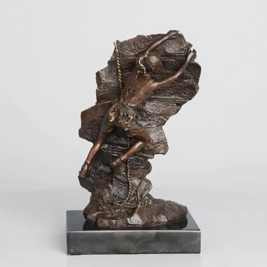 This striking bronze sculpture portrays a female rock climber captured in a moment of intense ascent, embodying both physical strength and mental determination. Created using the traditional lost-wax casting method, the sculpture showcases exceptional craftsmanship and attention to detail. The climber’s body is pressed closely against the rugged rock surface, with one arm reaching upward in pursuit of the next hold—an expressive gesture that conveys motion, tension, and purpose.