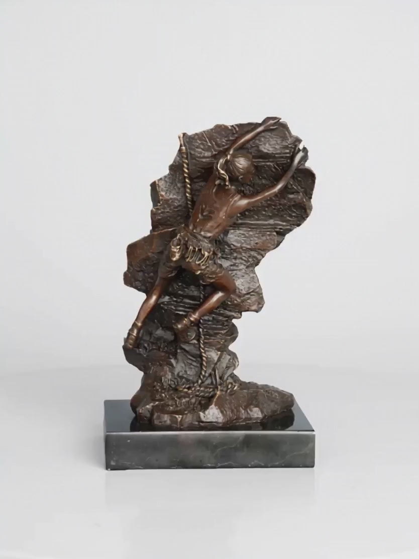 This striking bronze sculpture portrays a female rock climber captured in a moment of intense ascent, embodying both physical strength and mental determination. Created using the traditional lost-wax casting method, the sculpture showcases exceptional craftsmanship and attention to detail. The climber’s body is pressed closely against the rugged rock surface, with one arm reaching upward in pursuit of the next hold—an expressive gesture that conveys motion, tension, and purpose.