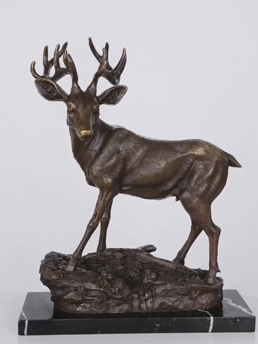 Handcrafted bronze stag sculpture featuring detailed antlers and naturalistic base. Lost-wax cast deer statue on marble base, ideal for luxury home decor.